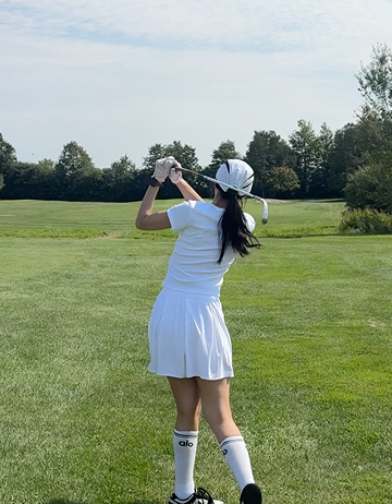 Playing golf on a green